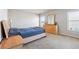 Bright bedroom with a wooden bed frame, dresser with mirror, and natural light from two windows at 615 Ceremony Way, Acworth, GA 30102