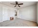 Bedroom with ceiling fan, neutral walls, and carpet, featuring 2 doors for convenience at 615 Ceremony Way, Acworth, GA 30102