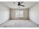 Large, naturally lit bedroom with neutral carpeting, ceiling fan, and window with blinds at 615 Ceremony Way, Acworth, GA 30102