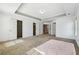 Large bedroom with a tray ceiling, open closet, carpet, and multiple doors, offering ample space at 615 Ceremony Way, Acworth, GA 30102