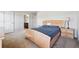Cozy bedroom featuring a wooden bed frame, carpet, and a lamp on a nightstand, with an ensuite bathroom at 615 Ceremony Way, Acworth, GA 30102