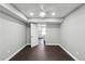 Bedroom with hardwood floors and ceiling fan, connecting to kitchen at 615 Ceremony Way, Acworth, GA 30102