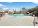 Large community pool with waterslide, lounge chairs, umbrellas and a two-story clubhouse in a wooded area at 615 Ceremony Way, Acworth, GA 30102