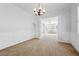 Elegant dining area with chandelier lighting, wainscoting, and open access to the living room at 615 Ceremony Way, Acworth, GA 30102