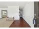 Elegant foyer with hardwood floors, wainscoting detail, and view to carpeted living room at 615 Ceremony Way, Acworth, GA 30102