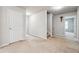 Neutral colored carpeted hallway showing a door and partial view of the staircase at 615 Ceremony Way, Acworth, GA 30102