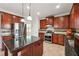 Stylish kitchen with stainless steel appliances, granite countertops, and cherry wood cabinetry at 615 Ceremony Way, Acworth, GA 30102