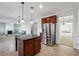 Open concept kitchen with stainless steel appliances, a center island, and views of the living area at 615 Ceremony Way, Acworth, GA 30102