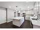 Modern kitchen featuring a large island, white cabinets, stainless steel appliances, and hardwood floors at 615 Ceremony Way, Acworth, GA 30102