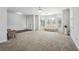 Bright living room featuring large bay windows, neutral carpet, and wainscoting detail at 615 Ceremony Way, Acworth, GA 30102