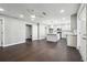 Spacious living room with hardwood floors connecting to kitchen and a door way at 615 Ceremony Way, Acworth, GA 30102