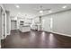 Open living room with hardwood floors connecting kitchen and an access door to outside at 615 Ceremony Way, Acworth, GA 30102