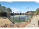 Well-maintained community tennis court with fencing, lighting, and a smooth surface, ideal for recreational play at 615 Ceremony Way, Acworth, GA 30102