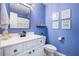 Bright blue bathroom with a white vanity, modern fixtures, and charming decor at 2069 Brightleaf Way # 123, Marietta, GA 30060