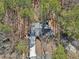 Aerial view of a home nestled among trees and greenery at 320 Spyglass Blf, Alpharetta, GA 30022