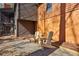 Backyard patio featuring comfortable Adirondack chairs on a gravel surface at 320 Spyglass Blf, Alpharetta, GA 30022