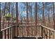 Cozy balcony features a wood railing with views of a forest at 320 Spyglass Blf, Alpharetta, GA 30022