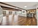 Open concept basement with wood floors, built-in cabinets, and bar at 320 Spyglass Blf, Alpharetta, GA 30022