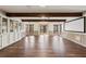 Open concept basement with wood floors, built-in cabinets, and projector screen at 320 Spyglass Blf, Alpharetta, GA 30022