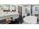 A spacious bathroom features a soaking tub, double sink vanity, and ample storage at 320 Spyglass Blf, Alpharetta, GA 30022