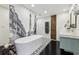 Bright bathroom featuring a modern vanity, freestanding tub, and Eiffel Tower wall decor at 320 Spyglass Blf, Alpharetta, GA 30022