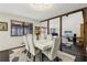 Elegant dining area with modern decor, seating for six, and natural light streaming through large windows at 320 Spyglass Blf, Alpharetta, GA 30022