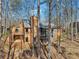 Exterior of the house with balcony and chimney surrounded by tall trees at 320 Spyglass Blf, Alpharetta, GA 30022