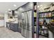 Bright kitchen with stainless steel refrigerator, built-in pantry, and marble backsplash at 320 Spyglass Blf, Alpharetta, GA 30022