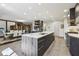 Open-concept kitchen with large island, modern appliances, and view of the dining area at 320 Spyglass Blf, Alpharetta, GA 30022