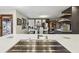 Kitchen sink with stainless steel faucet, quartz countertop, and open floor plan at 320 Spyglass Blf, Alpharetta, GA 30022