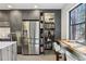 Kitchen with stainless steel refrigerator and a view of the well-stocked pantry at 320 Spyglass Blf, Alpharetta, GA 30022