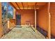 View of the back patio area with a gravel surface and covered porch at 320 Spyglass Blf, Alpharetta, GA 30022