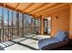 Relaxing screened porch featuring an outdoor lounge chair at 320 Spyglass Blf, Alpharetta, GA 30022