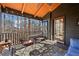 Relax on this screened porch with a ceiling fan, lights, and wooded views at 320 Spyglass Blf, Alpharetta, GA 30022