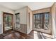 Sunroom with access to deck, wood floors and wood paneling at 320 Spyglass Blf, Alpharetta, GA 30022