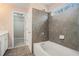 Bathroom featuring a tub, shower, and an open doorway to a walk-in closet at 3226 Wellington Sw Walk, Atlanta, GA 30331