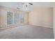 Spacious bedroom featuring a vaulted ceiling, ceiling fan and neutral carpet and paint at 3226 Wellington Sw Walk, Atlanta, GA 30331