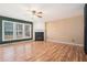 Spacious living room featuring hardwood floors, a cozy fireplace, and large windows offering ample natural light at 3226 Wellington Sw Walk, Atlanta, GA 30331