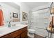 Bright bathroom with a tub-shower combo, a vanity with storage, and a decorative mirror at 236 Augusta Walk, Canton, GA 30114