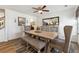 Open-concept dining area featuring a rustic wooden table, cushioned bench, and elegant chairs at 236 Augusta Walk, Canton, GA 30114