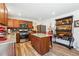 Kitchen featuring wood cabinets, granite countertops, stainless steel appliances, and hardwood floors at 236 Augusta Walk, Canton, GA 30114