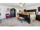 Spacious main bedroom featuring an armoire, bench, and a comfortable seating area at 236 Augusta Walk, Canton, GA 30114