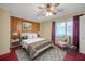 Bedroom with wood paneling, ceiling fan, window and red carpet, staged with furniture at 2570 Bradford Ne Sq, Atlanta, GA 30345