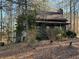 View of house exterior surrounded by trees and natural landscape at 3121 Bonds Lake Nw Rd, Conyers, GA 30012