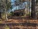 House viewed from the woods, with some natural landscape at 3121 Bonds Lake Nw Rd, Conyers, GA 30012