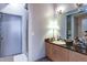 Well-lit bathroom with a modern vanity, granite countertop, and glass-enclosed shower at 5300 Peachtree Rd # 2604, Atlanta, GA 30341