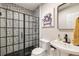 Modern bathroom featuring a black and white tile shower and contemporary fixtures at 915 Homer Rd, Woodstock, GA 30188