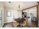 Cozy dining room adjacent to the living room, highlighted by hardwood floors and a decorative chandelier at 915 Homer Rd, Woodstock, GA 30188