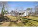 Beautiful exterior of home with metal roof and large front yard with fire pit at 915 Homer Rd, Woodstock, GA 30188