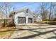 Exterior angle of home with spacious two-car garage and a basketball hoop at 915 Homer Rd, Woodstock, GA 30188